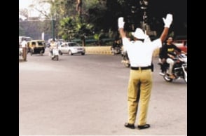Traffic cop gets slapped for stopping man from jumping signal