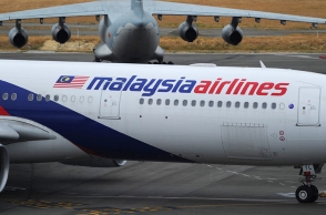 Malaysia Airlines turns back after man threatens to detonate bomb