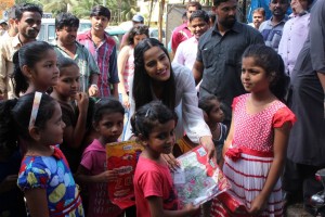 Poonam Pandey Distribute Raincoats To Street Children