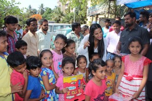 Poonam Pandey Distribute Raincoats To Street Children