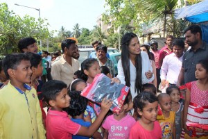 Poonam Pandey Distribute Raincoats To Street Children