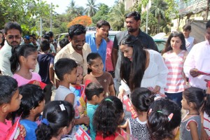 Poonam Pandey Distribute Raincoats To Street Children