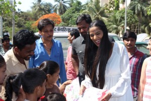 Poonam Pandey Distribute Raincoats To Street Children
