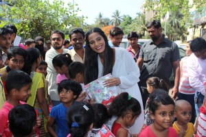 Poonam Pandey Distribute Raincoats To Street Children