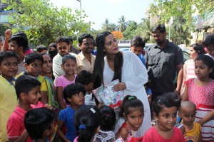 Poonam Pandey Distribute Raincoats To Street Children