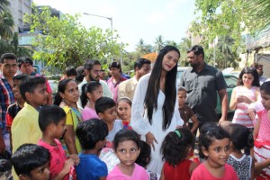 Poonam Pandey Distribute Raincoats To Street Children