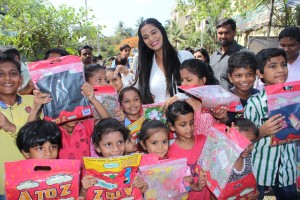 Poonam Pandey Distribute Raincoats To Street Children
