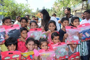 Poonam Pandey Distribute Raincoats To Street Children
