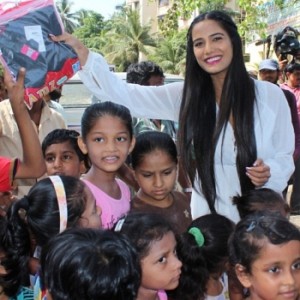 Poonam Pandey Distribute Raincoats To Street Children