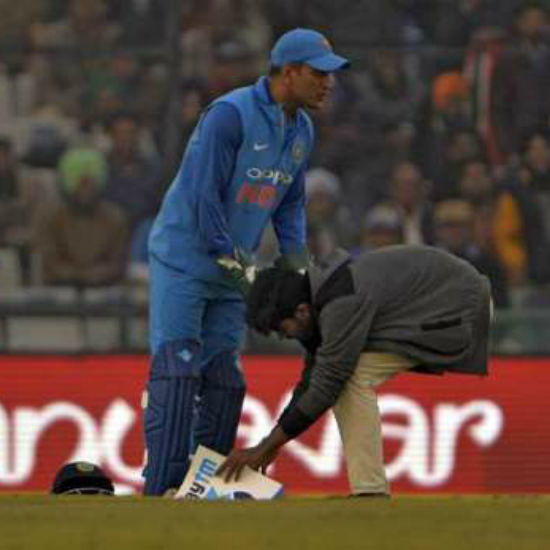 A fan breached security to touch Dhoni's feet in a match when Rohit Sharma hit his third double ton