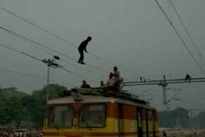 Man Dangling From Overhead Wire On Tracks Gets Rescued, Trains Halts For An Hour! 