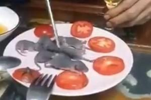 VIDEO: Man Dips Rat in Sauce, Eats It Alive
