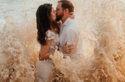 Waves crash beach wedding photo shoot of couple - photos viral