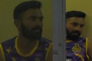 What was Dinesh Karthik doing in this team's dressing room wearing their jersey?