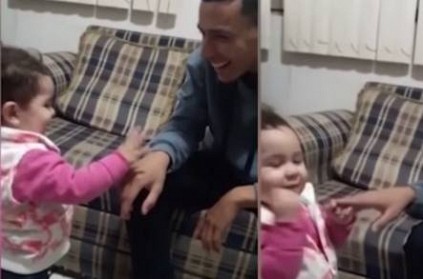 little girl using sign language to communicate with her dad