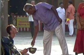 Russian tourists begs outside Kanchipuram temple
