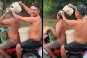 Watch Video: Two Men On Bike Take Bath While Riding; Gets Fined By Police