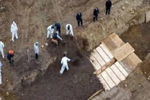 VIDEO: Drone Footage Shows Mass Grave Being Filled With Dozens of Coffins