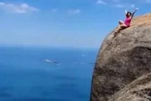 Video: Woman Tourist Posing On 2,800-Foot Mountain Edge, Leaves Twitter Divided!  