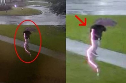 Video: Lightning strikes man walking with umbrella in rain