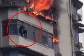 WATCH VIDEO: Man hangs from building to escape fire