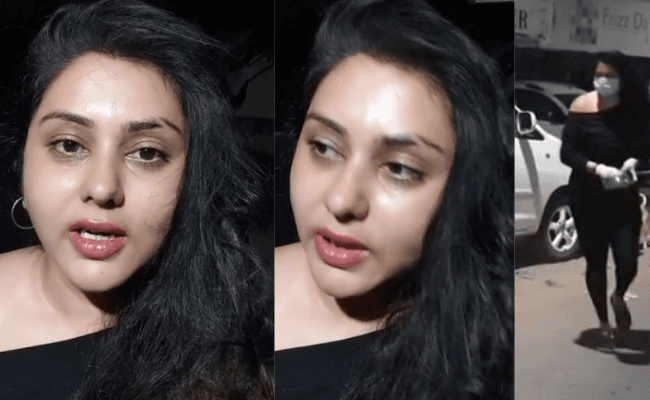 Actress Namitha comes out of the house to feed stray dogs