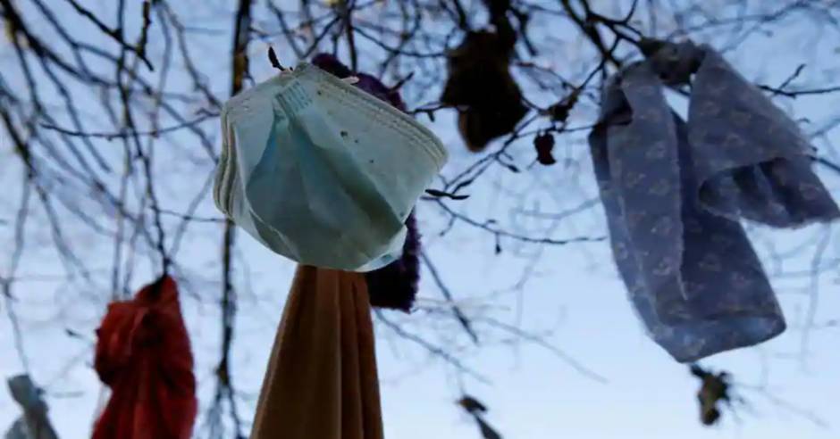 People hang masks on trees in hope of cure Covid-19