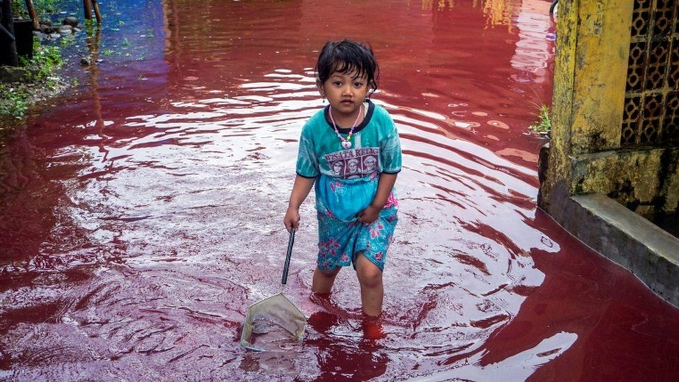 Indonesian village gets flooded with surreal red water