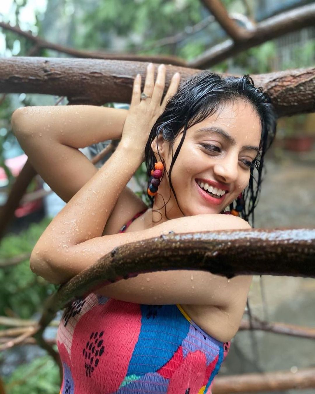 Deepika Singh poses beside tree uprooted by Cyclone Tauktae.