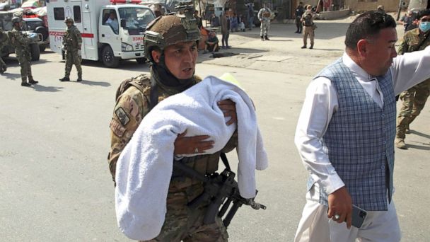 Parents handing over children veterans in Afghanistan