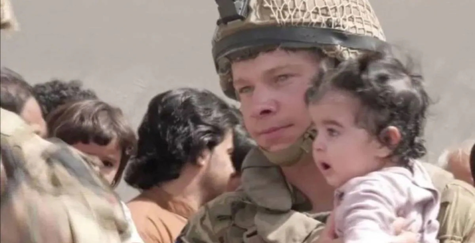 Parents handing over children veterans in Afghanistan
