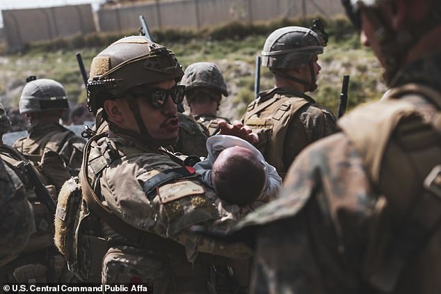 Afghan baby lifted by US Marine has been reunited with her father