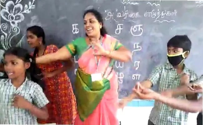 government school teacher using hit songs to teach her students