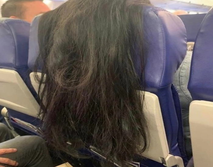 Photo of a woman traveling on a plane with long hair