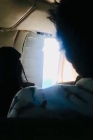 Passengers hold plane door closed after it flies open mid air