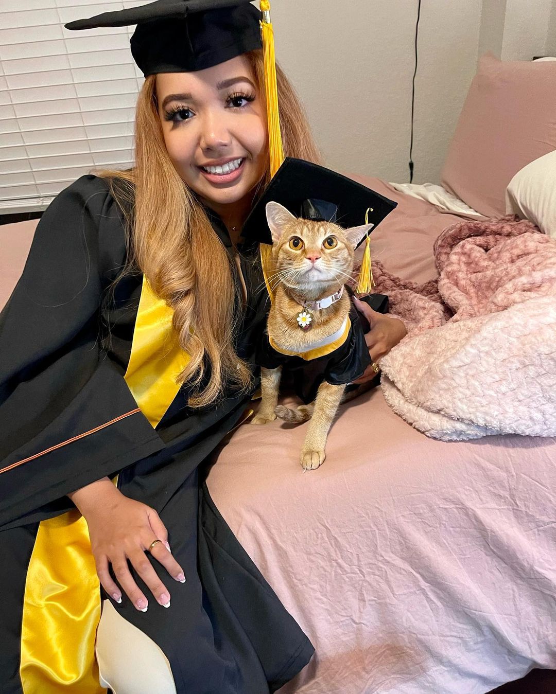 woman graduates from university along with her cat