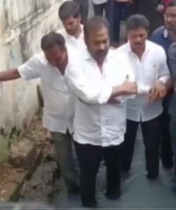 YSRCP MLA Sridhar Reddy stands in drain to protest against municipal o
