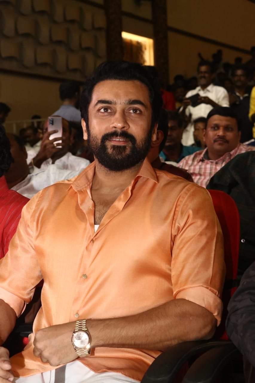 Actor Suriya showing Rolex watch to fans at Madurai