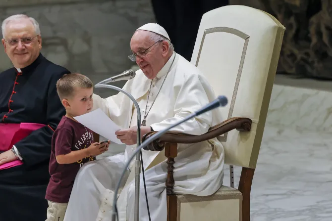 Pope Francis gets an unexpected visitor on stage