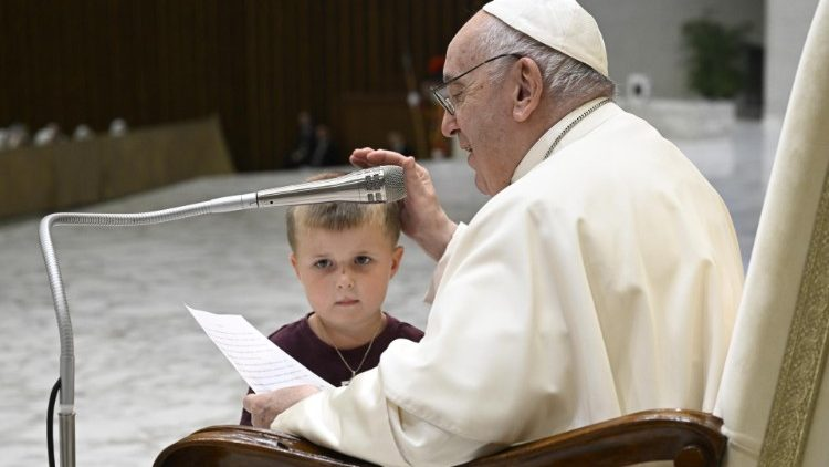 Pope Francis gets an unexpected visitor on stage