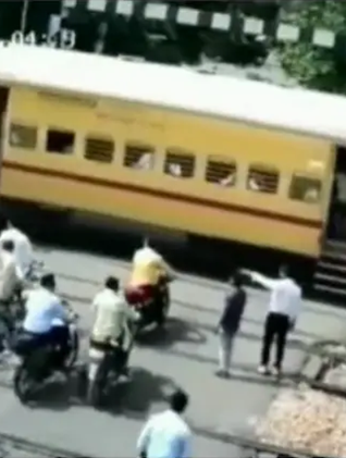 Man bike crushed under speeding train Video goes viral