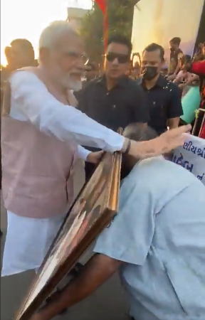 PM Modi gets down his car to accept portrait of his mother