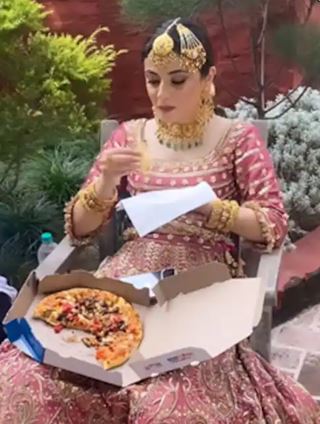 bride enjoys a pizza before the wedding ceremonies video 
