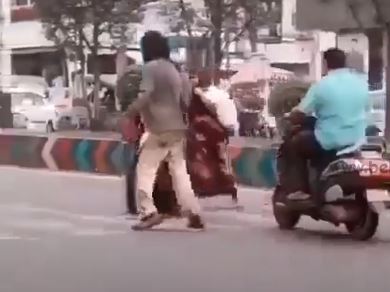 Demented man clears traffic for women and kid cross road 