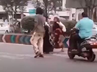 Demented man clears traffic for women and kid cross road 