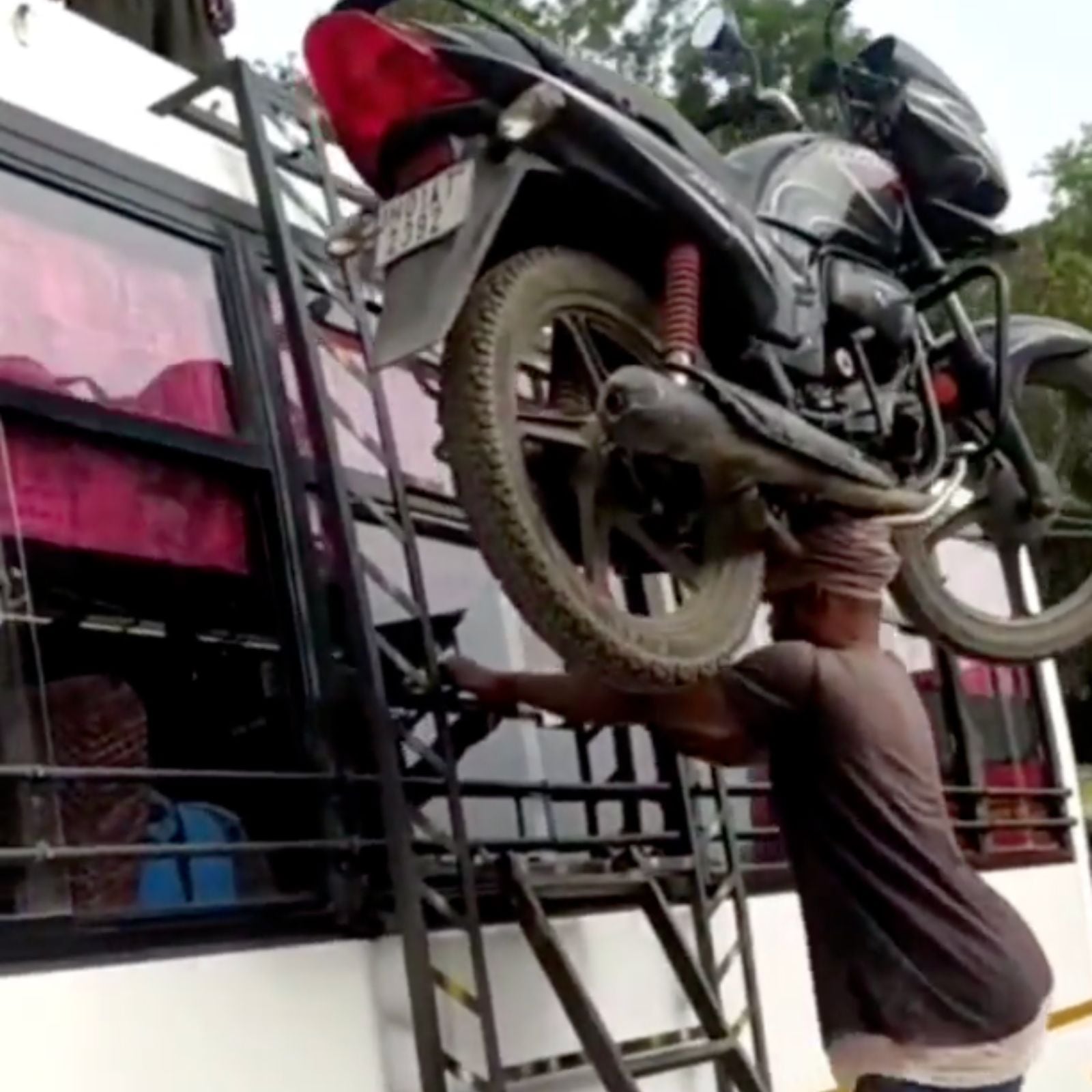 man climbs bike on his head in bus ladder video amazed people