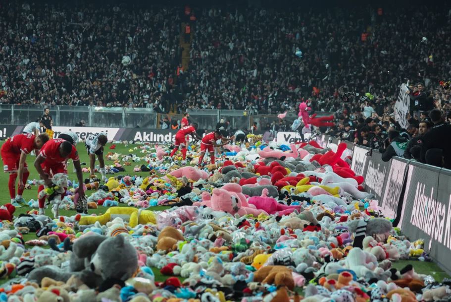 Fans throw toys in football stadium for children in turkey
